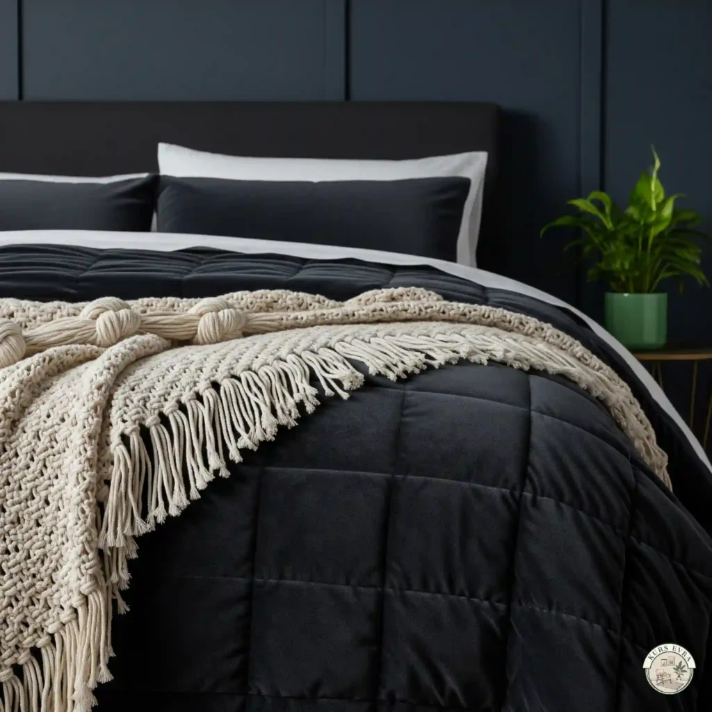 A close-up of a bed with a charcoal velvet quilt, macramé throw, and a potted plant on a bedside table.